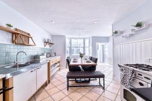 a kitchen with a table and a sink and a stove at Deluxe Gem of Bath - Football Table - Sleeps 10 in Bath