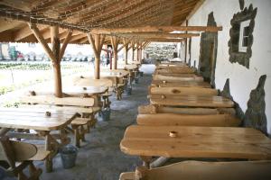 a row of wooden tables in a building at Impresja Krasiczyn in Przemyśl