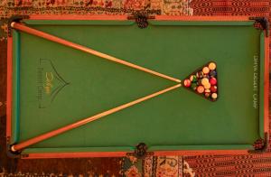 a clock made out of pool balls and sticks at Dihya desert camp in Merzouga