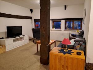 a living room with a couch and a tv at Ferienwohnung Gitta 