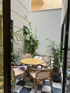 a table and chairs on a patio with plants at The SoHo in Islamabad