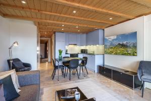 a kitchen and living room with a table and chairs at Kinohaus 7 in Wengen