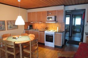 a kitchen with a table and a dining room at Hemfjällsbyn 17A in Sälen