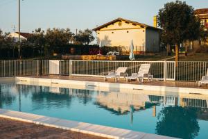 two chairs sitting next to a swimming pool at B&B Rosa Dalfonsina in Villalfonsina