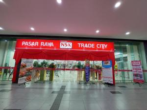 a store front with a red sign in a mall at 3 Elements* The Garden* MRT2* Wifi* Self Check-In in Kampong Batu Sembilan