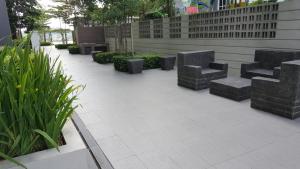 a row of benches sitting in a courtyard at 3 Elements* The Garden* MRT2* Wifi* Self Check-In in Kampong Batu Sembilan