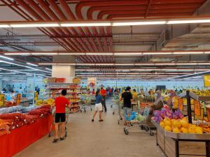 a group of people grocery shopping in a supermarket at 3 Elements* The Garden* MRT2* Wifi* Self Check-In in Kampong Batu Sembilan