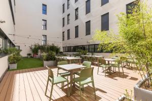 a patio with tables and chairs in a building at Micampus Getafe II Student Residence in Getafe