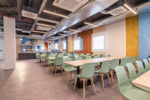 a conference room with tables and chairs at Micampus Getafe II Student Residence in Getafe +18 photos