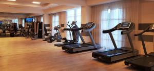a gym with a row of tread machines in a room at Sheraton Rome Parco de Medici in Rome