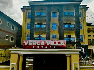 a yellow building with a sign in front of it at Verla Villa Estate in Buea