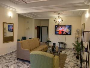 a living room with a couch and a table at Verla Villa Estate in Buea