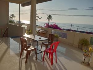 a dining room with a table and chairs and the ocean at Homestay Nhật Thi in Mui Ne +36 photos