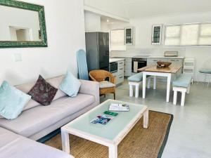 a living room with a couch and a table at Summerhill Self-Catering Accommodation St Francis Bay in St Francis Bay