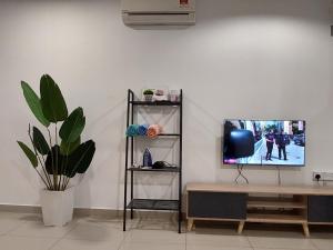a living room with a tv and a table at 3 Elements* The Garden* MRT2* Wifi* Self Check-In in Kampong Batu Sembilan