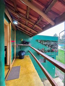 a balcony of a house with a blue wall at Casa Apu Honey Moon Suite Pague duas noites minimo e a terceira e brinde menos feriados in Natividade da Serra