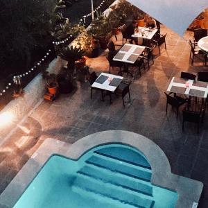 an overhead view of a restaurant with a swimming pool at Villa Lorenzo in Cala Figuera