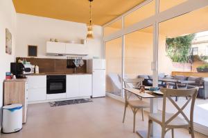 a kitchen and living room with a table and chairs at Medea Mondello Holiday in Mondello