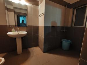 a bathroom with a sink and a mirror at The Choice of families APARTMENTS in Islamabad