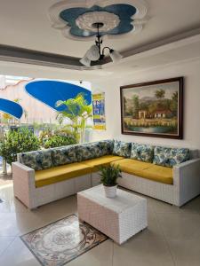 a living room with a couch and a table at Hotel Zamba in Girardot