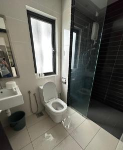 a bathroom with a toilet and a shower and a sink at Kyra Homestay Centrus SOHO Cyberjaya *wifi and pool* in Cyberjaya