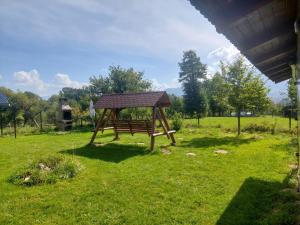 a park with a bench in the grass at Casa Tamara in Bran +10 photos