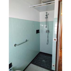 a bathroom with a shower with blue tiles at Bright villa with private garden - Beahost Rentals in Caorle