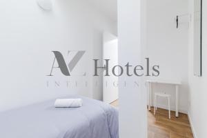 a white bedroom with a white bed and a sign at AYZ Luis Cabrera-Auto check-in property in Madrid