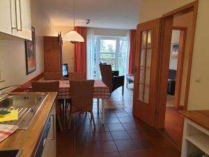 a kitchen and dining room with a table and chairs at Ferienhaus Jantje Moe 4 in Horumersiel