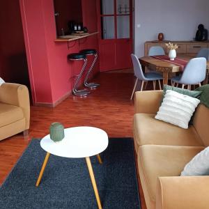 a living room with a couch and a table at La campagne à la ville in Sablé-sur-Sarthe