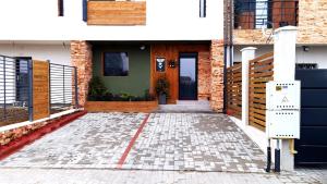a front door of a house with a brick building at Mogosoaia High Living Apartment in Chitila