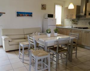 a kitchen and living room with a table and chairs at Zaffiro Blu in Bellaria-Igea Marina