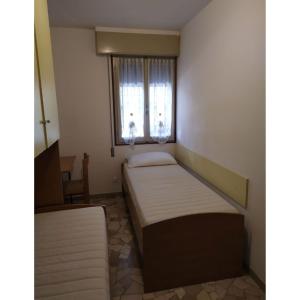a small room with two beds and a window at Bright villa with private garden - Beahost Rentals in Caorle