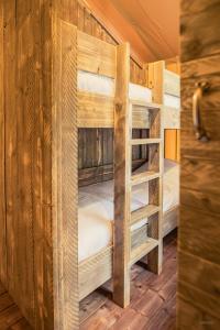 a couple of bunk beds in a room at Tente lodge Jacuzzi privatif en pleine nature in Thiel-sur-Acolin