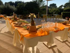 a table with a pineapple centerpiece on top of it at San Giuseppe Casa per Ferie in Quercianella