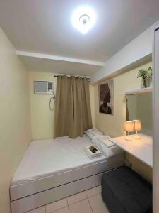a small room with a bed and a desk at Condo For Rent in Ortigas (KIMEA Deluxe) in Manila