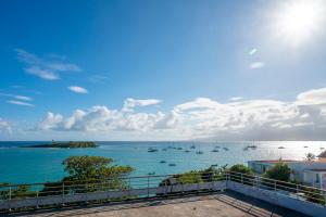 a view of the ocean from a balcony at ILET TURQUOISE in Le Gosier