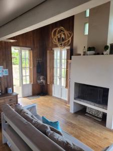 a living room with a couch and a fireplace at La Cabaña de Vito in La Paloma