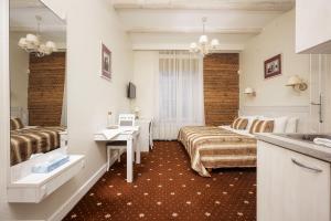a hotel room with two beds and a sink at Art Hotel in Druskininkai
