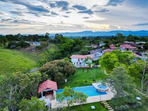 an aerial view of a house with a swimming pool at Finca Villa Sophia! in Quimbaya