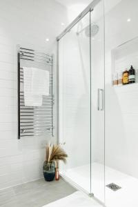 a shower with a glass door in a bathroom at Elegant central London flat - ideal for weekend city break in London