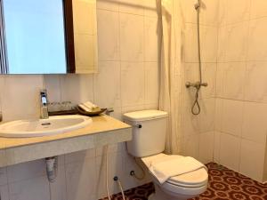 a bathroom with a toilet and a sink and a shower at The One by Nika in Siem Reap