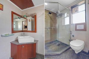 a bathroom with a toilet and a sink and a shower at The Royal Galaxy - Sec. 12 Dwarka Metro Station in New Delhi