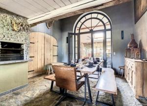 a large kitchen with a table and a large window at The Lodge Ardenne in Tailles