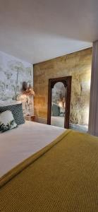 a bedroom with a large bed and a mirror at Iris la fleuriste in Talence