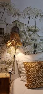 a bedroom with a bed with a wall mural of trees at Iris la fleuriste in Talence