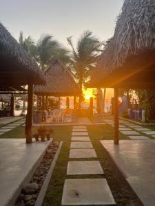 a pathway leading to a resort with palm trees at San Carlos Surf Resort & Eco Lodge in San Carlos