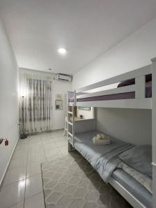 a bedroom with two bunk beds and a hallway at Benoni 3 Bedroom - Farah Biz Empire Homestay in Papar