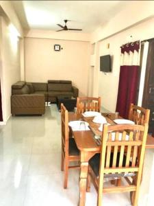 a living room with a table and chairs and a couch at Reef Hotel in Hyderabad