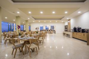 restauracja ze stołami i krzesłami oraz kuchnia w obiekcie V Hotel Delphi w mieście Delfy